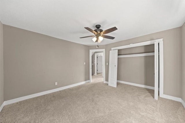 unfurnished bedroom featuring ceiling fan, baseboards, a closet, and light carpet