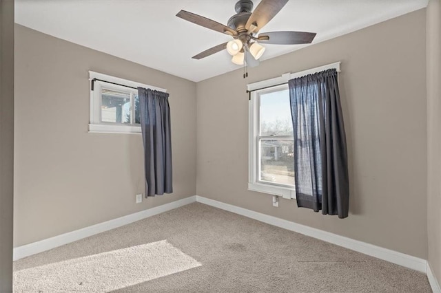 empty room featuring baseboards, carpet floors, and ceiling fan