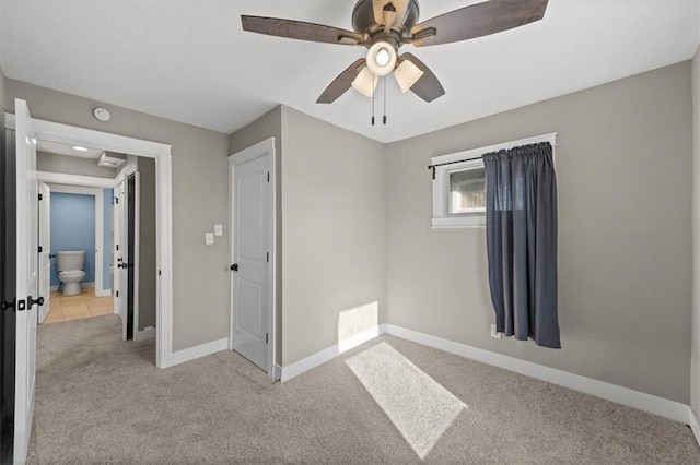 unfurnished bedroom with ceiling fan, baseboards, and carpet floors