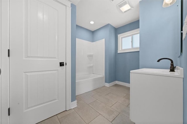 bathroom with vanity, bathing tub / shower combination, visible vents, and baseboards