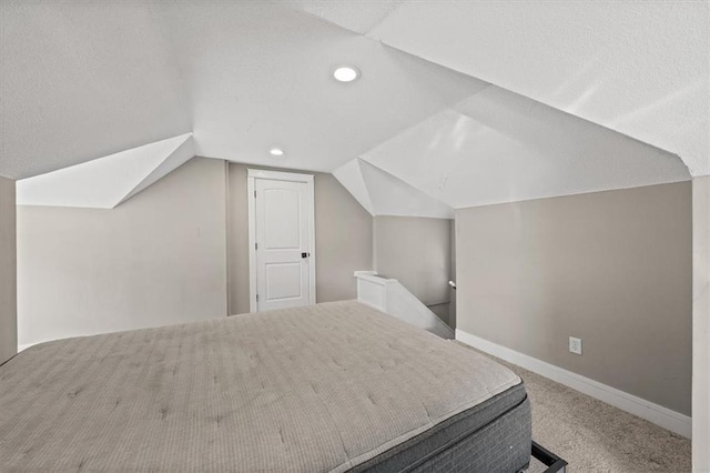 carpeted bedroom featuring recessed lighting, baseboards, and lofted ceiling