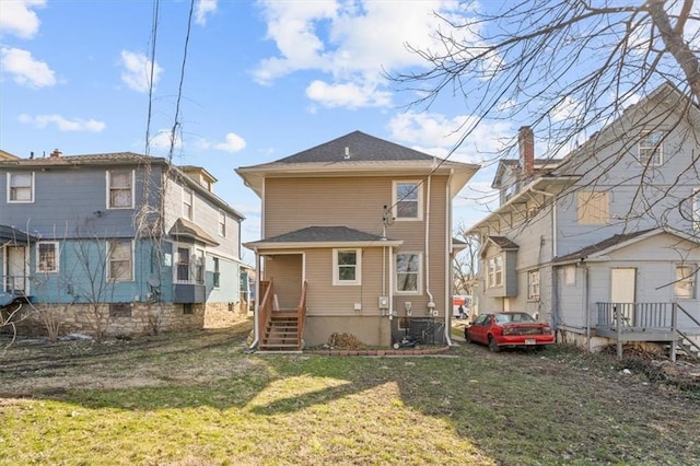 rear view of property with a lawn