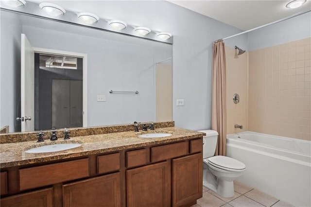 bathroom with tile patterned floors, toilet, shower / bath combo, and a sink