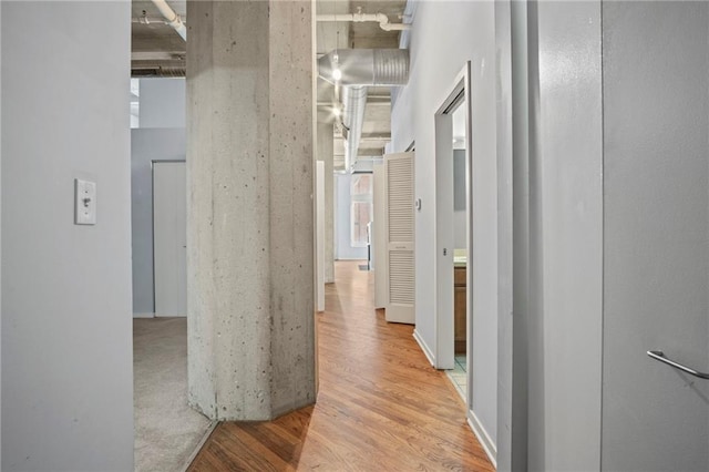 hall featuring a high ceiling and wood finished floors