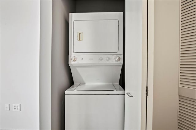 washroom with laundry area and stacked washer / dryer