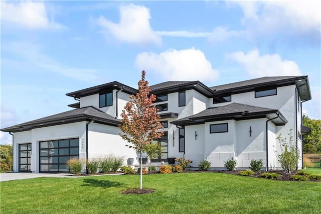 rear view of house with a garage, a yard, concrete driveway, and stucco siding