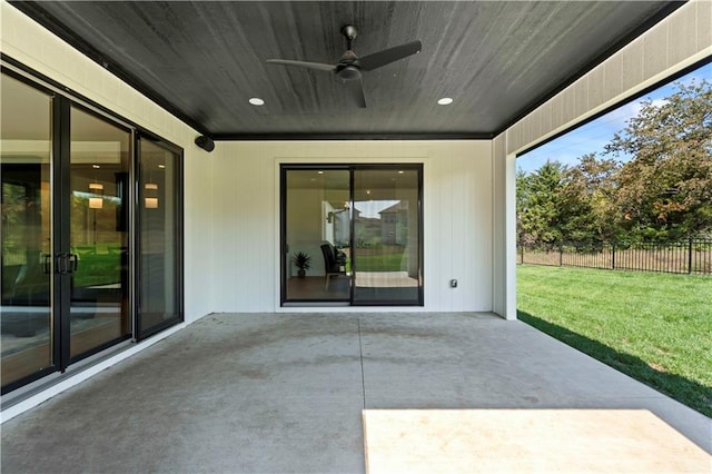 view of patio / terrace with ceiling fan and fence