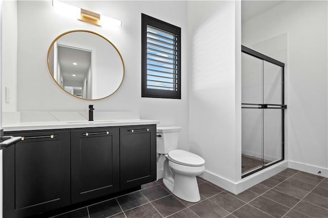 bathroom featuring toilet, a shower stall, tile patterned flooring, and vanity