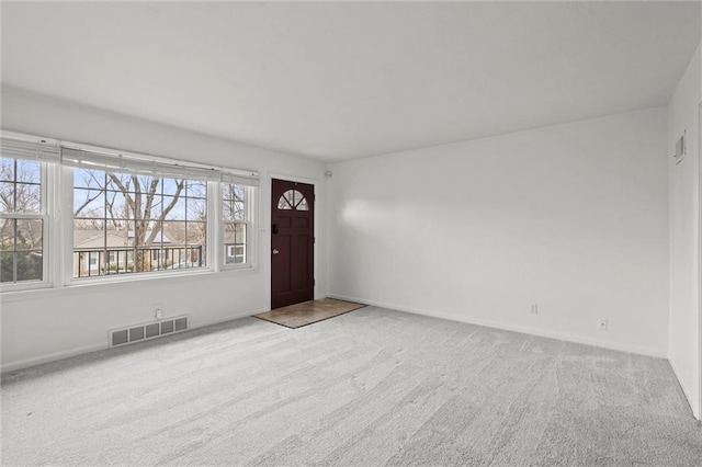 entryway featuring carpet, visible vents, and baseboards