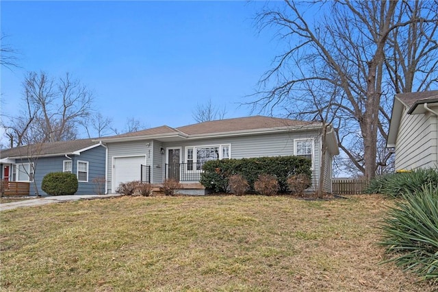 ranch-style home featuring a garage and a front lawn