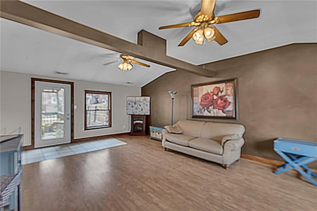 living room with a fireplace, wood finished floors, a ceiling fan, baseboards, and vaulted ceiling