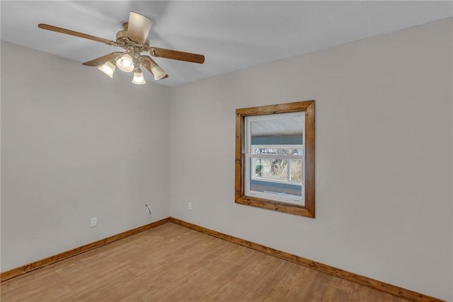 unfurnished room with light wood-type flooring, ceiling fan, and baseboards