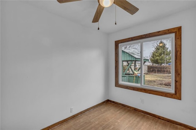 spare room featuring light wood-style flooring and baseboards