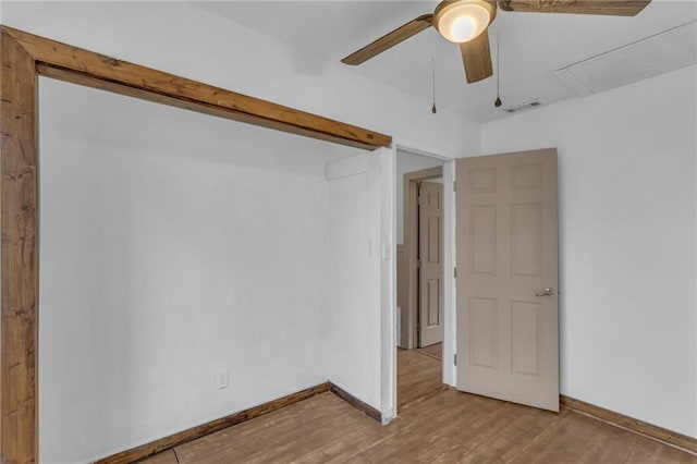 spare room featuring visible vents, ceiling fan, light wood-style flooring, and baseboards