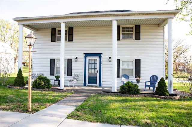 greek revival house with a porch and a front yard