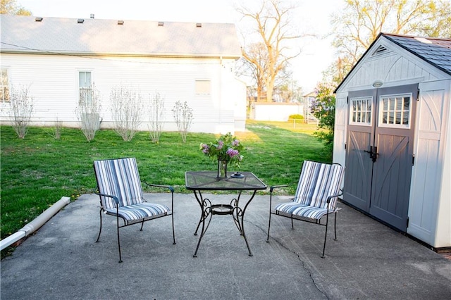 view of patio with outdoor dining area, an outdoor structure, and a storage unit