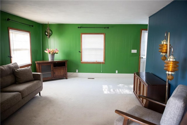 carpeted living room featuring baseboards and visible vents