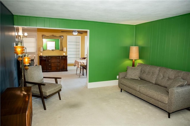 carpeted living room with a ceiling fan