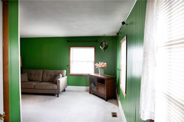 sitting room featuring baseboards, visible vents, and light colored carpet
