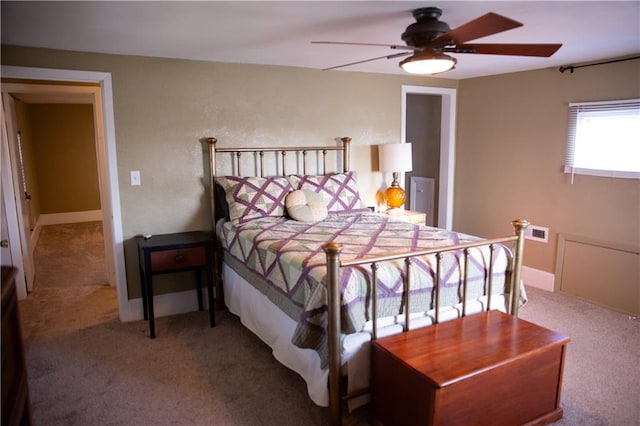 bedroom with carpet floors, visible vents, and a ceiling fan