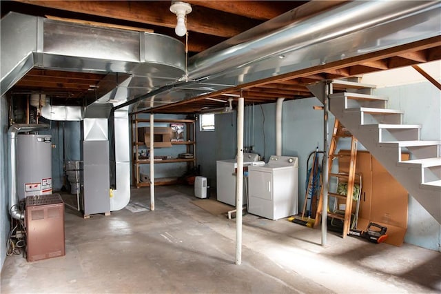 below grade area featuring stairway, heating unit, and washer and clothes dryer