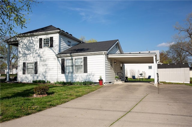 view of front of home featuring a carport, a front yard, and concrete driveway