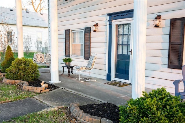view of exterior entry with covered porch