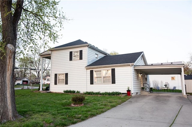 view of front facade featuring a front lawn, driveway, and a carport