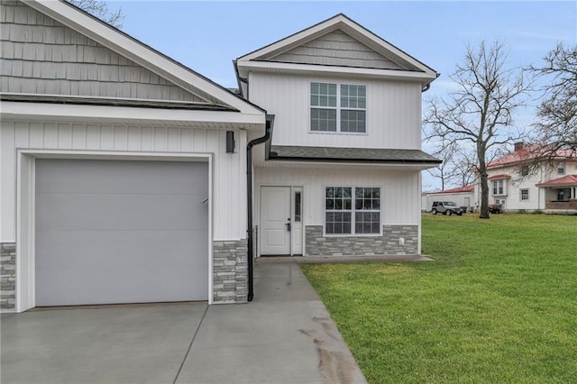 craftsman-style home with a front lawn, driveway, stone siding, an attached garage, and a shingled roof