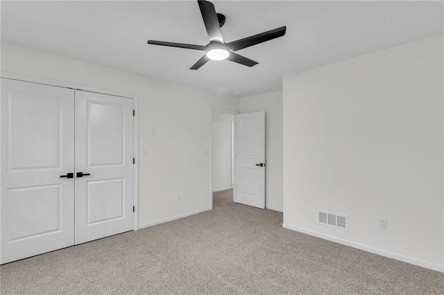 unfurnished bedroom with visible vents, baseboards, carpet flooring, a closet, and a ceiling fan