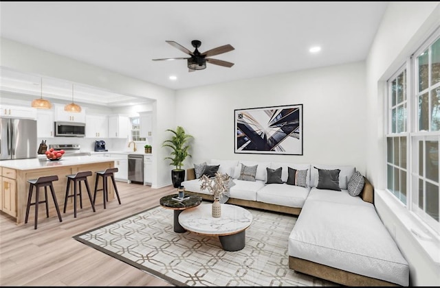 living room with recessed lighting, a ceiling fan, and light wood finished floors