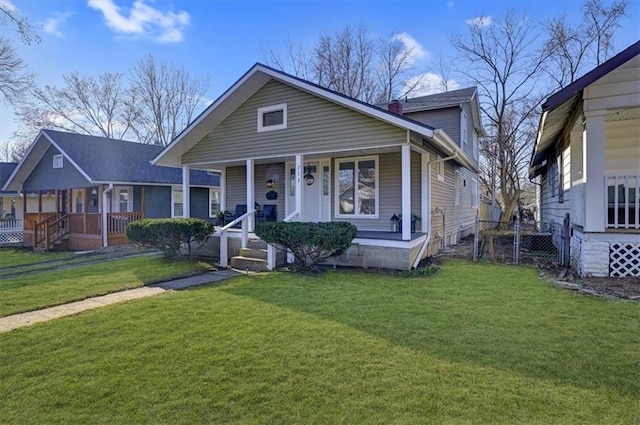 view of front of home featuring a porch, a front lawn, and a chimney