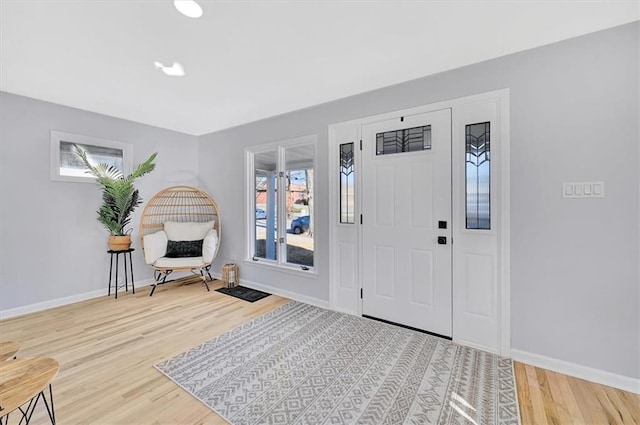 entrance foyer featuring baseboards and wood finished floors