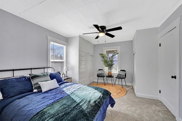 bedroom featuring carpet flooring, ceiling fan, baseboards, and ornamental molding