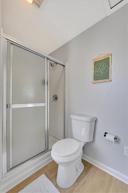 full bathroom featuring wood finished floors, visible vents, baseboards, a shower stall, and toilet