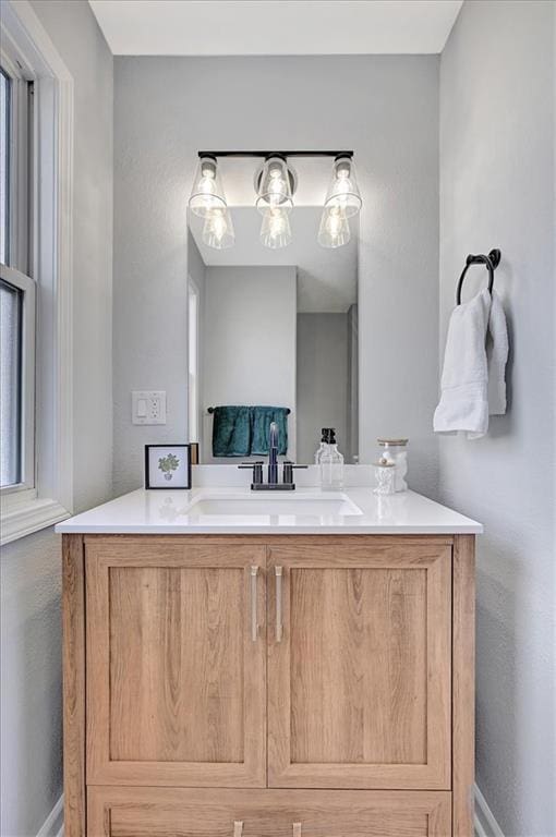 bathroom with vanity and baseboards