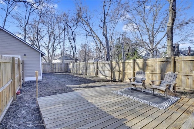 wooden deck with a fenced backyard