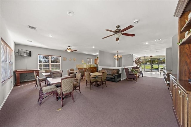 carpeted dining space featuring recessed lighting, visible vents, and ceiling fan with notable chandelier