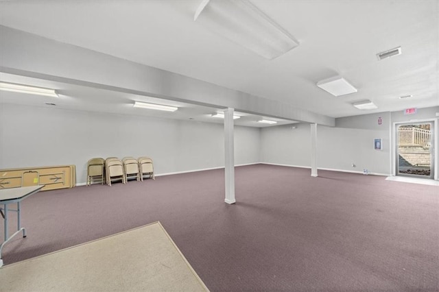 below grade area featuring carpet floors, visible vents, and baseboards