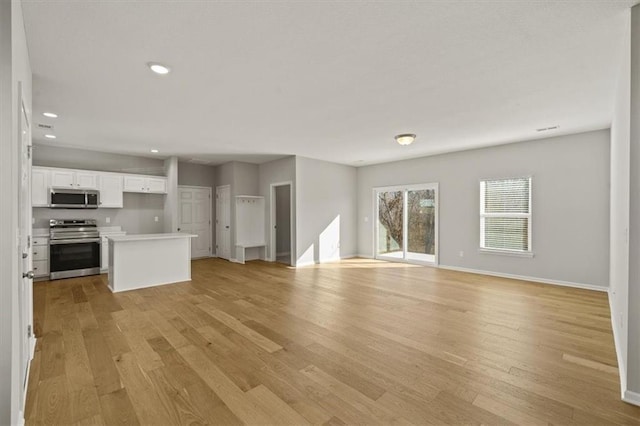 unfurnished living room featuring light wood-style floors, baseboards, and recessed lighting