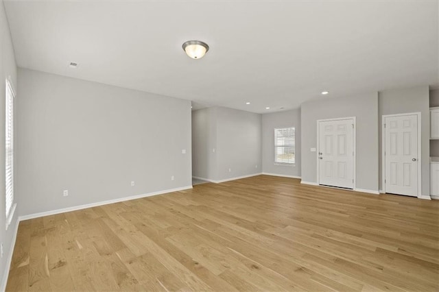 unfurnished living room featuring light wood-style flooring, baseboards, and recessed lighting