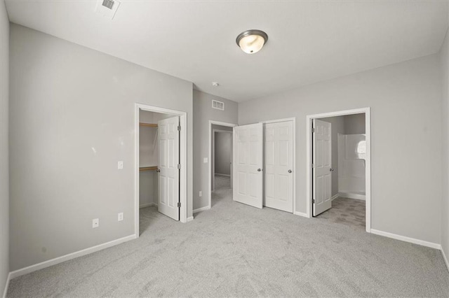 unfurnished bedroom with carpet flooring, visible vents, and baseboards