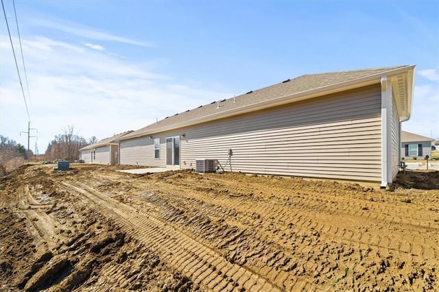 rear view of property featuring central AC unit