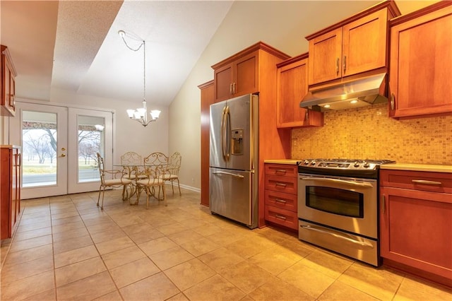 kitchen featuring brown cabinetry, lofted ceiling, french doors, under cabinet range hood, and appliances with stainless steel finishes