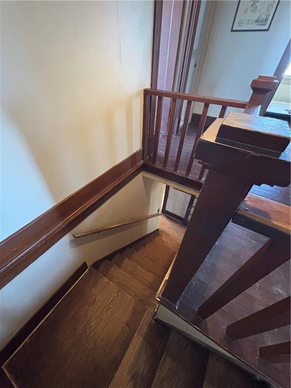 stairway featuring wood finished floors