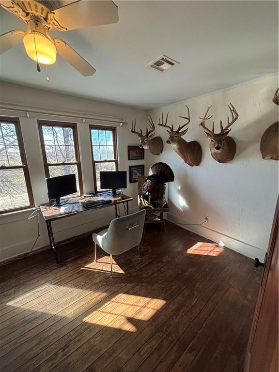 home office with ceiling fan, baseboards, visible vents, and dark wood finished floors