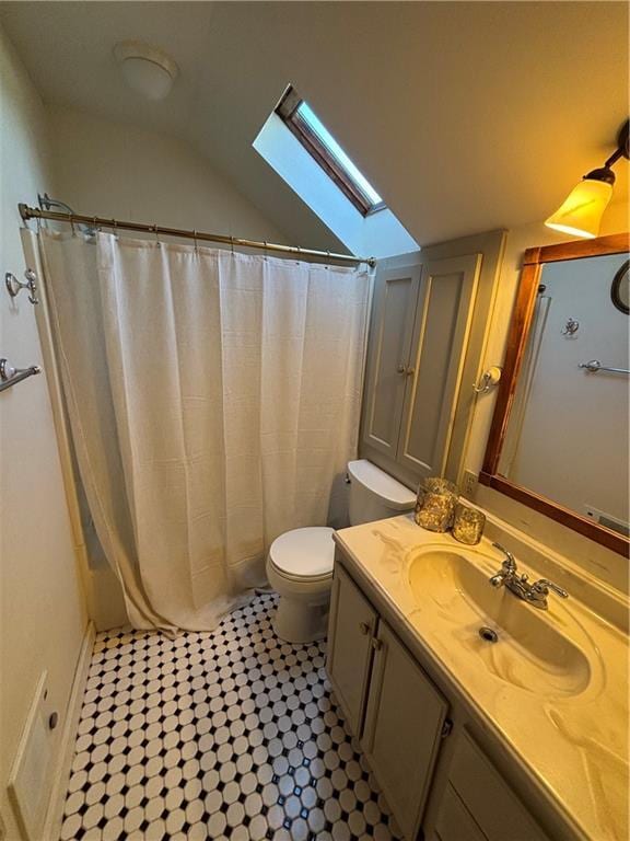 full bath with vaulted ceiling with skylight, vanity, toilet, and a shower with curtain