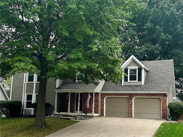 view of front of property featuring a shingled roof, concrete driveway, a front lawn, a garage, and brick siding