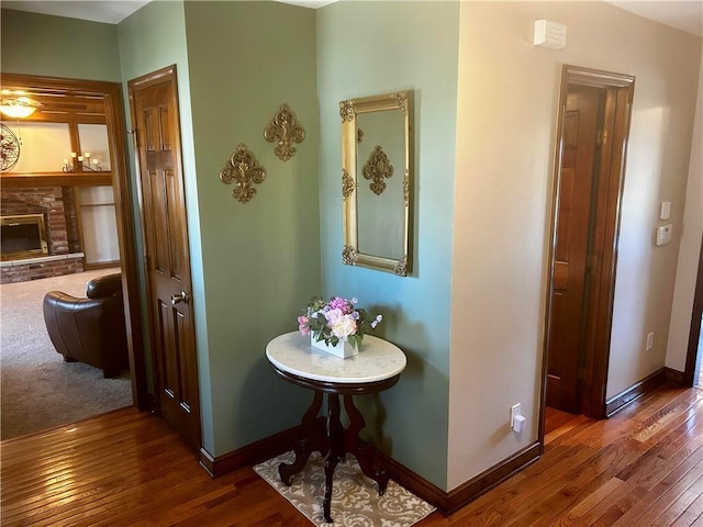 hall featuring baseboards and wood-type flooring