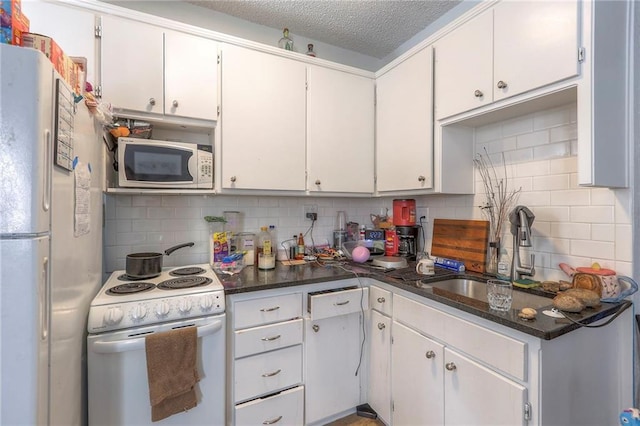 kitchen featuring white appliances, a sink, and decorative backsplash